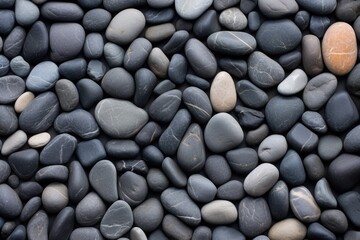 Fototapeta na wymiar broad view of flat slate pebbles creating a smooth texture