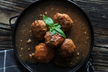 Meatballs with tomato sauce . on a wooden table. dinner