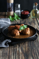 Meatballs with tomato sauce . on a wooden table. dinner
