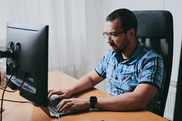 Portrait professional man programmer working concentrated on computer in diverse offices. Modern IT...