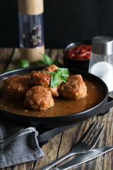 Meatballs with tomato sauce . on a wooden table. dinner