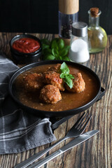 Meatballs with tomato sauce . on a wooden table. dinner