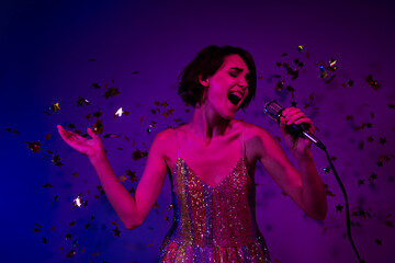 Photo of excited celebrity lady singing in nightclub on birthday event occasion isolated color neon...