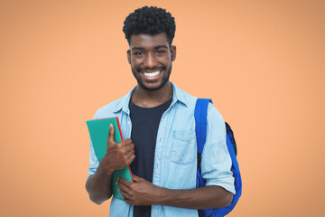 Laughing black male student with beard and paperwork