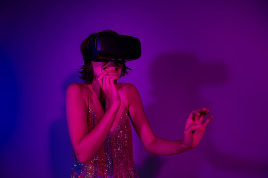 Fototapeta Photo of lady player gamer using vr box see illusion in thriller horror game isolated bright neon color background