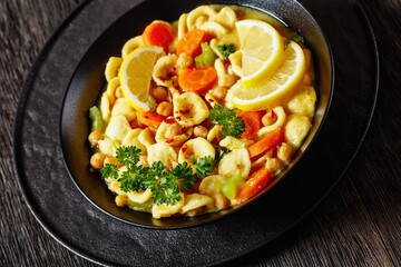 orecchiette pasta chickpea soup in black bowl