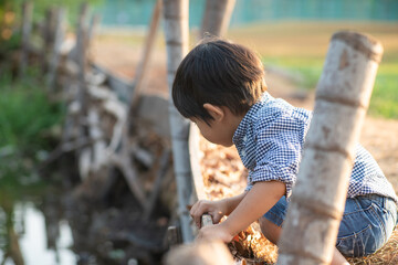 Asian preschool boy enjoying outdoor recreation city park sunset light - Powered by Adobe