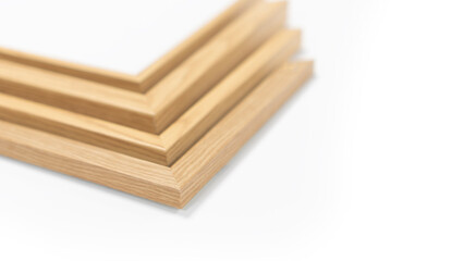 A pile of empty picture frames and mouldings on a clean white background