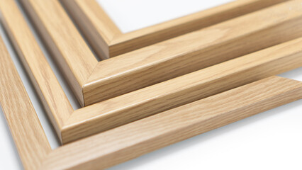 A pile of empty picture frames and mouldings on a clean white background