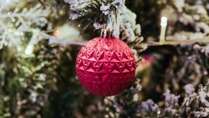 Christmas ball on pine tree branch blurred background