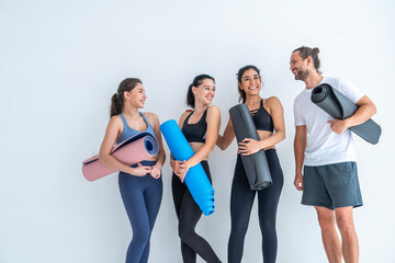Health, lifestyle and exercise concepts.Group of people with exercise friends and female yoga instructor wearing sports clothes, exercising, trainer teaching yoga ้hold mat in exercise club studio