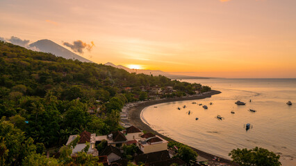 Sunset on the island of Bali with Amed beach and Mount Agung in the background. Indonesia