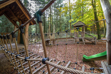 Playground in the woods at Bad Wildbad, Black Forest, Germany, wooden construction for climbing with plastic slide
