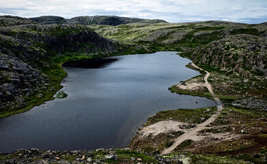 Naklejka na ściany i meble Small cold lake on polar rocky tundra of Teriberka, Kola Peninsula