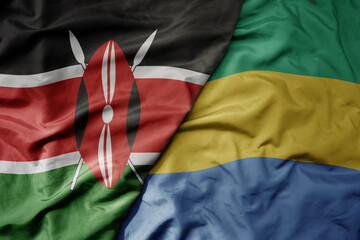 big waving national colorful flag of kenya and national flag of gabon .