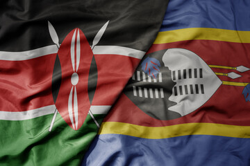big waving national colorful flag of kenya and national flag of eswatini .