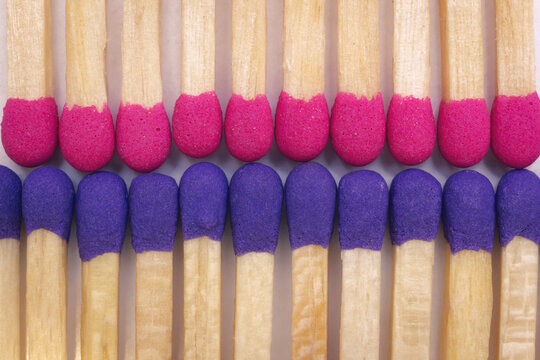 Pink and blue safety matches. Concept of the confrontation and flammable conflict. Macro photography.