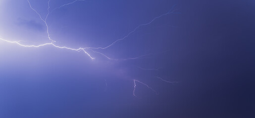 Fototapeta premium Lightning from the black and blue sky. Storm clouds.