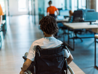 A wheelchair-bound businessman seamlessly navigates through contemporary business offices,...