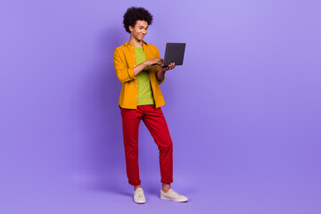 Full length photo of successful nice man wear stylish clothes typing texting letter isolated on purple color background