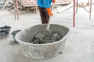 Worker mix cement in plastic tube