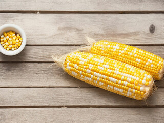 Top view fresh raw corn yellow plant on a dark-light table color green photo