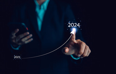 Business growing in 2024. Businessman with virtual increasing technical graph and up arrow for...