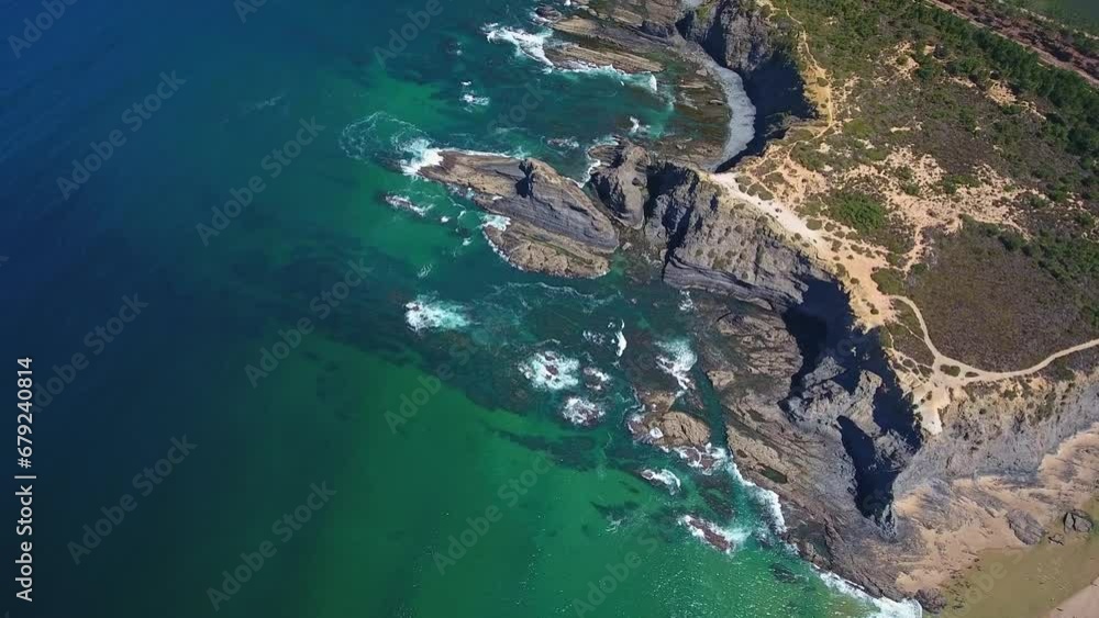 Canvas Prints Top view of waves crashing on rocks. Aerial drone top down bird's eye view of sea blue waves crashing on rocks and sand. Aerial view