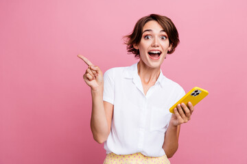 Photo of excited astonished woman with bob hair dressed shirt hold smartphone indicating empty...