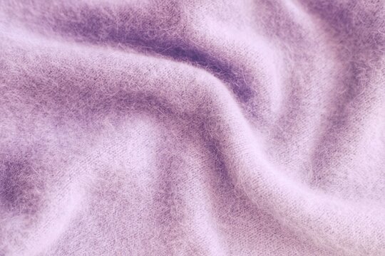 Knitwear, pink angora. Natural woolen fabric, fragment of a sweater.