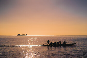A group of friends or adventurers enjoy the sea as they paddle together in a kayak, sharing the...