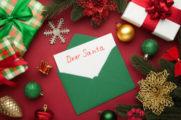 Fototapeta na wymiar Dear Santa - letter to Santa Claus with Christmas toys on red background.