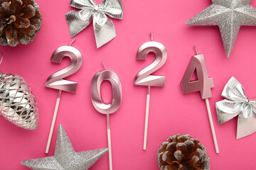 2024 Happy New Year and silver Christmas decoration on pink background.