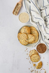 Healthy cookies with the addition of flax seeds and sesame seeds in a plate, top view.