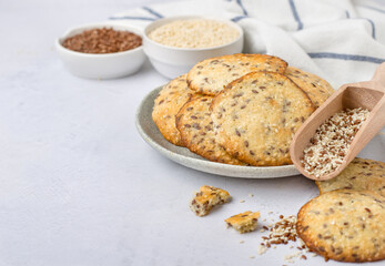Healthy cookies with the addition of flax seeds and sesame seeds in a plate. Horizontal, free space for notes.