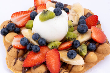 Waffle with ice cream and fresh fruits.
