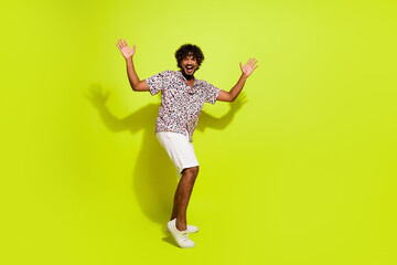 Fototapeta na wymiar Full length photo of nice young man dance energetic hands have fun wear trendy leopard print garment isolated on yellow color background