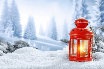 Vintage red lamp with fire in snow flakes. Wooden desk cover of snow and frost with empty place for...