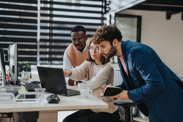 Multiracial business group works together in modern office, planning global expansion and discussing market research for profit growth and e-commerce success.