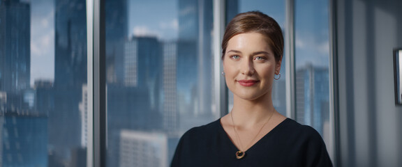 Close Up Beautiful Portrait of Caucasian Businesswoman Posing Next to Window in Big City Office...
