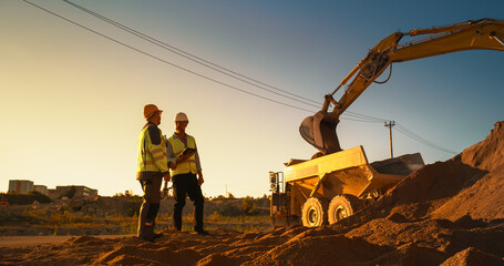 Caucasian Real Estate Investor With Tablet And Project Manager Talking On Construction Site Of...