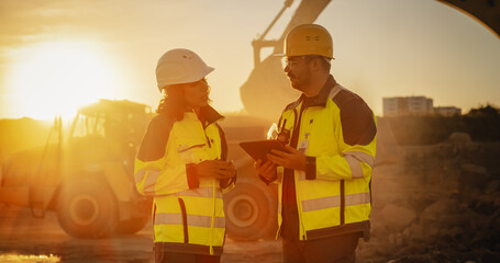 Cinematic Golden Hour Shot Of Construction Site: Caucasian Male Civil Engineer And Hispanic Female...