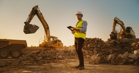 Caucasian Male Real Estate Investor Wearing Protective Goggles And Using Tablet On Construction...
