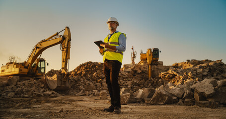 Caucasian Male Real Estate Investor Wearing Protective Goggles And Using Tablet On Construction...