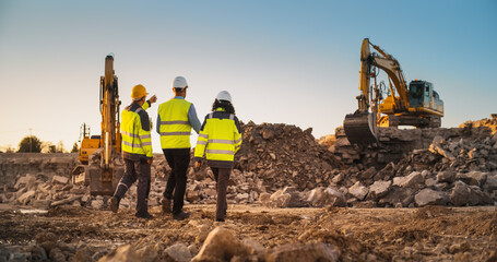 Construction Site With Excavators on Sunny Day: Diverse Team Of Male And Female Specialists Walking...