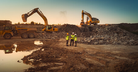 Aerial Drone Shot Of Construction Site With Heavy Machinery On Bright Sunny Day: Diverse Team of...