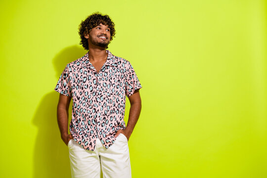 Photo Of Attractive Young Man Hands Pockets Look Empty Space Dressed Stylish Pink Leopard Print Clothes Isolated On Yellow Color Background