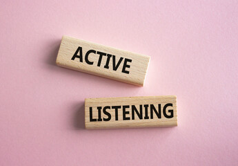 Active listening symbol. Wooden blocks with words Active listening. Beautiful pink background. Business and Active listening concept. Copy space.
