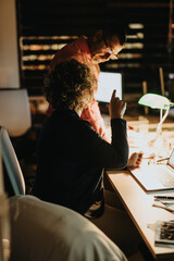 Diverse business team working late at night, collaborating on a project for business growth and...