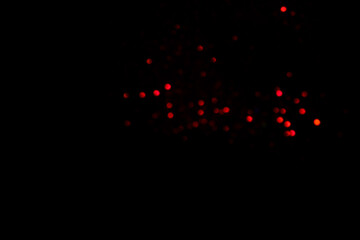 Red blurred bokeh lights on black background. Glitter sparkle confetti for celebrate. Overlay for your design